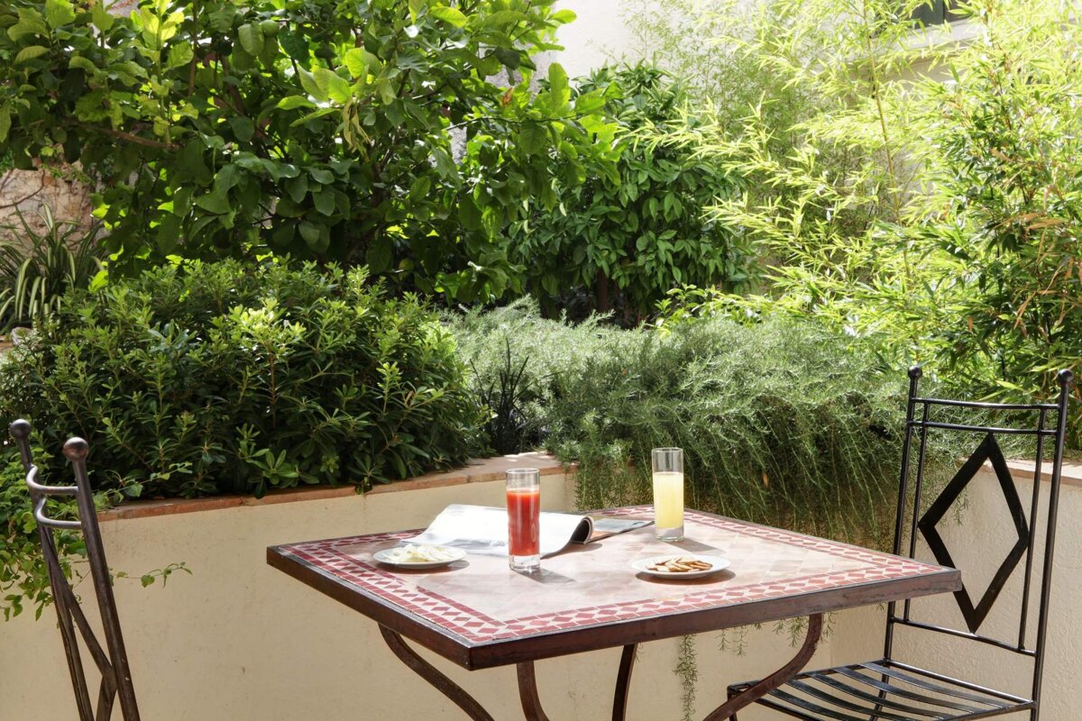 A table with a glass of orange juice and a magazine on it