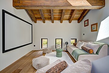 A living room with a couch and a projector screen