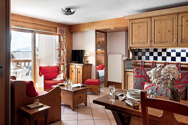 A living room with a couch a table and a television