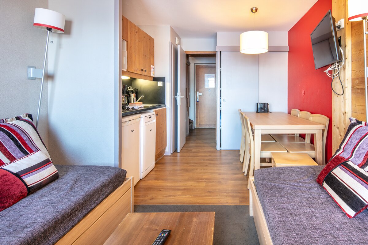 A living room with a couch a table and a television