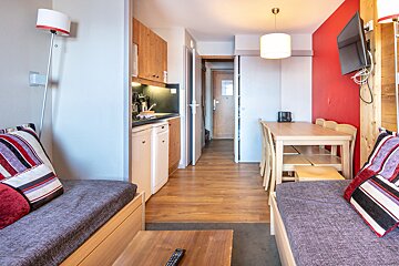 A living room with a couch a table and a television