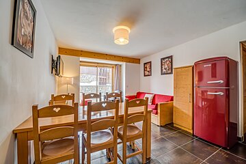 A room with a red refrigerator that says gorenje on it
