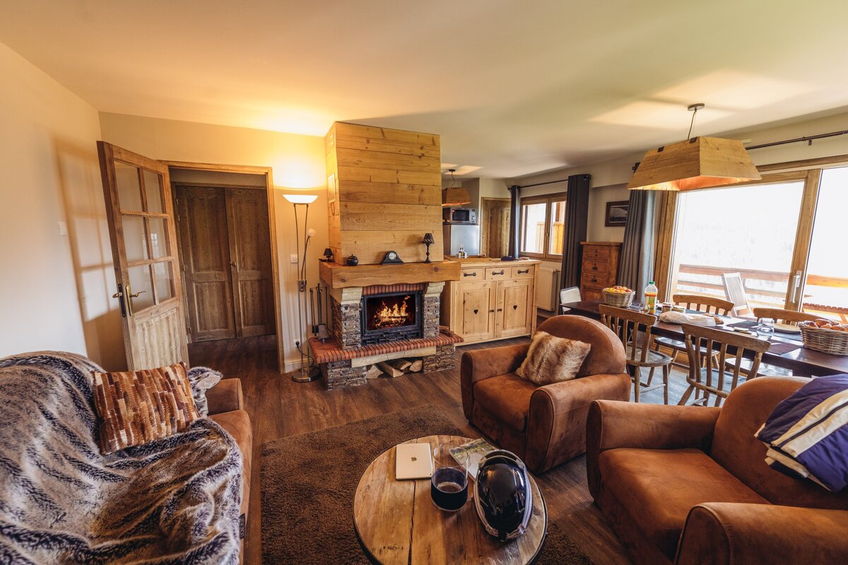 A living room with a fireplace and two chairs