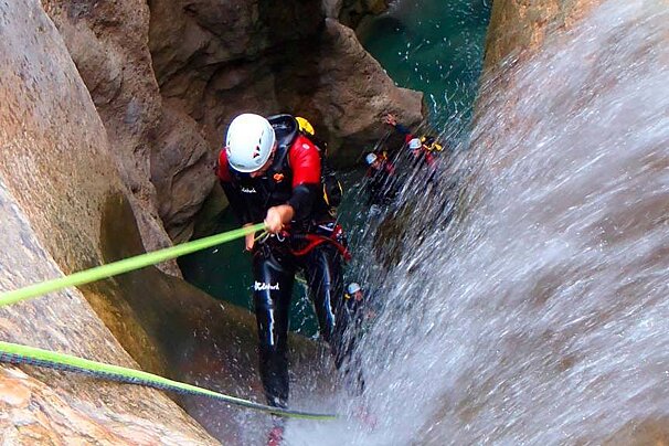 people canyoning on a river