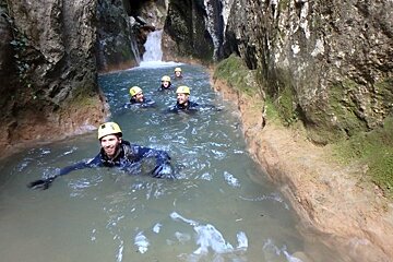 people canyoning on a river