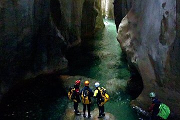 people canyoning on a river