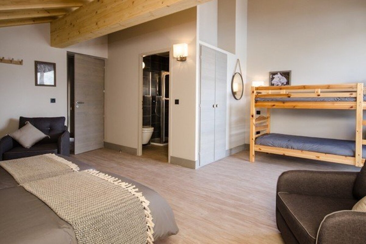 a room with multiple beds for families