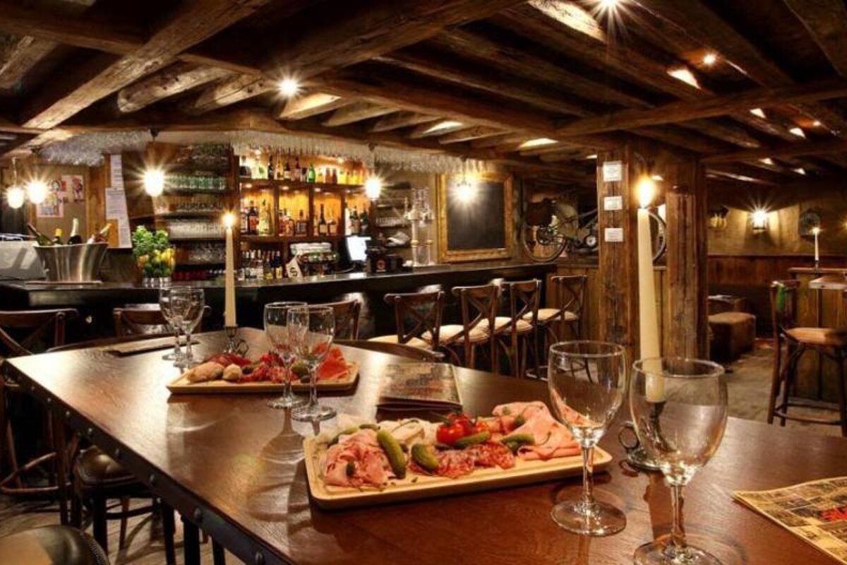 A restaurant with a few plates of food on the table