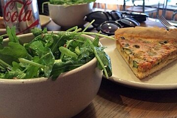 a green salad and a slice of quiche