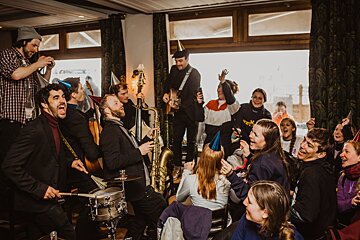 A man playing a saxophone in front of a crowd of people