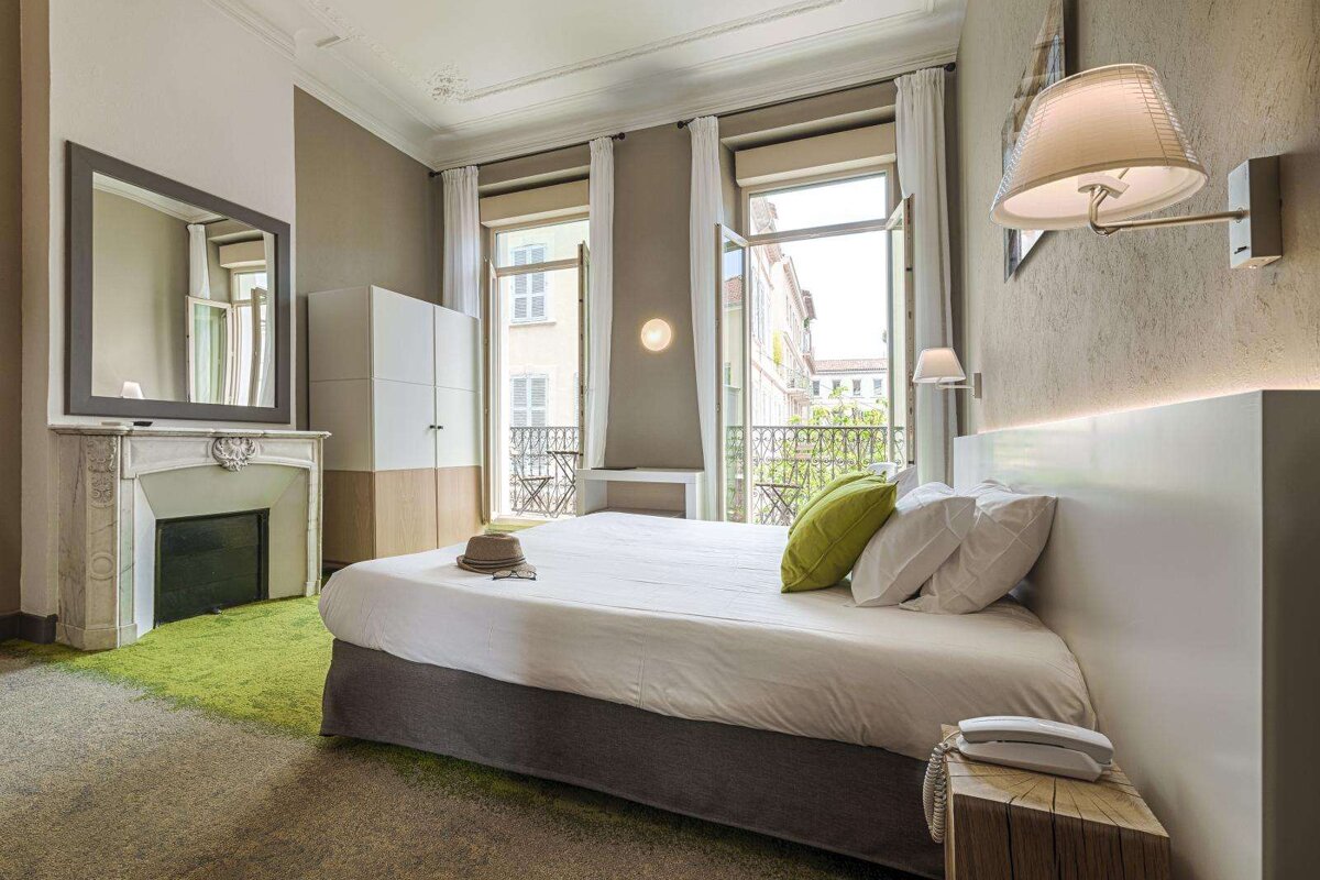 A hotel room with a large bed and a fireplace