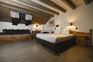 A hotel room with a bed and a couch