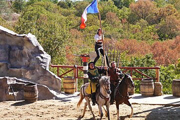 woman on men's shoulders on horseback at rocamadour