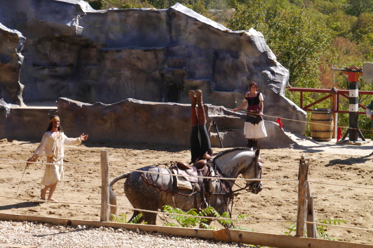 a woman upside down on a horse, rocamadour