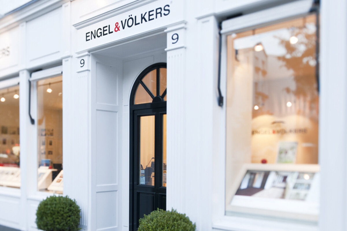 A white building with a sign that says engel & volkers