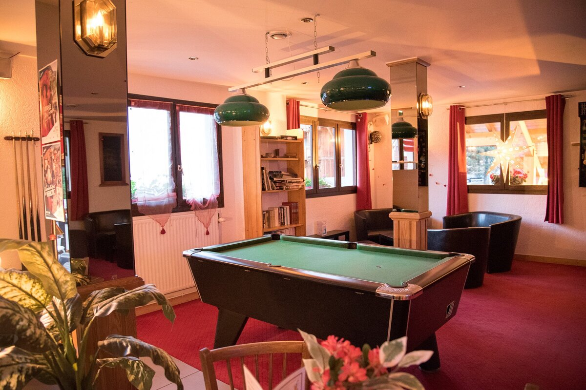 A pool table is in the middle of a room