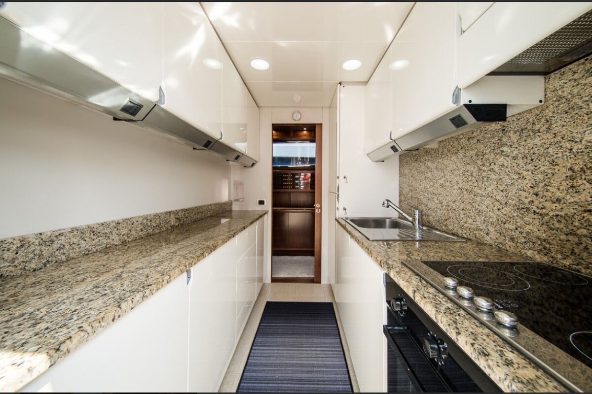 A kitchen with granite counter tops and white cabinets
