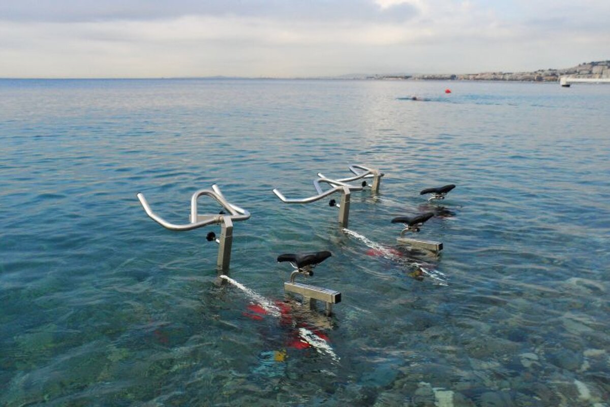 three exercise bikes in the sea