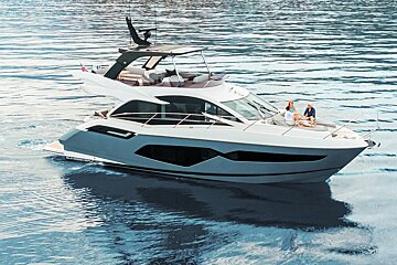 A gray and white yacht is floating on top of a body of water