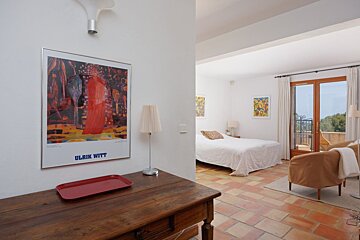 A bedroom with a ulrik witt poster on the wall