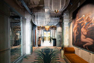 A hallway with a painting and a sign that says ' boutique ' on it