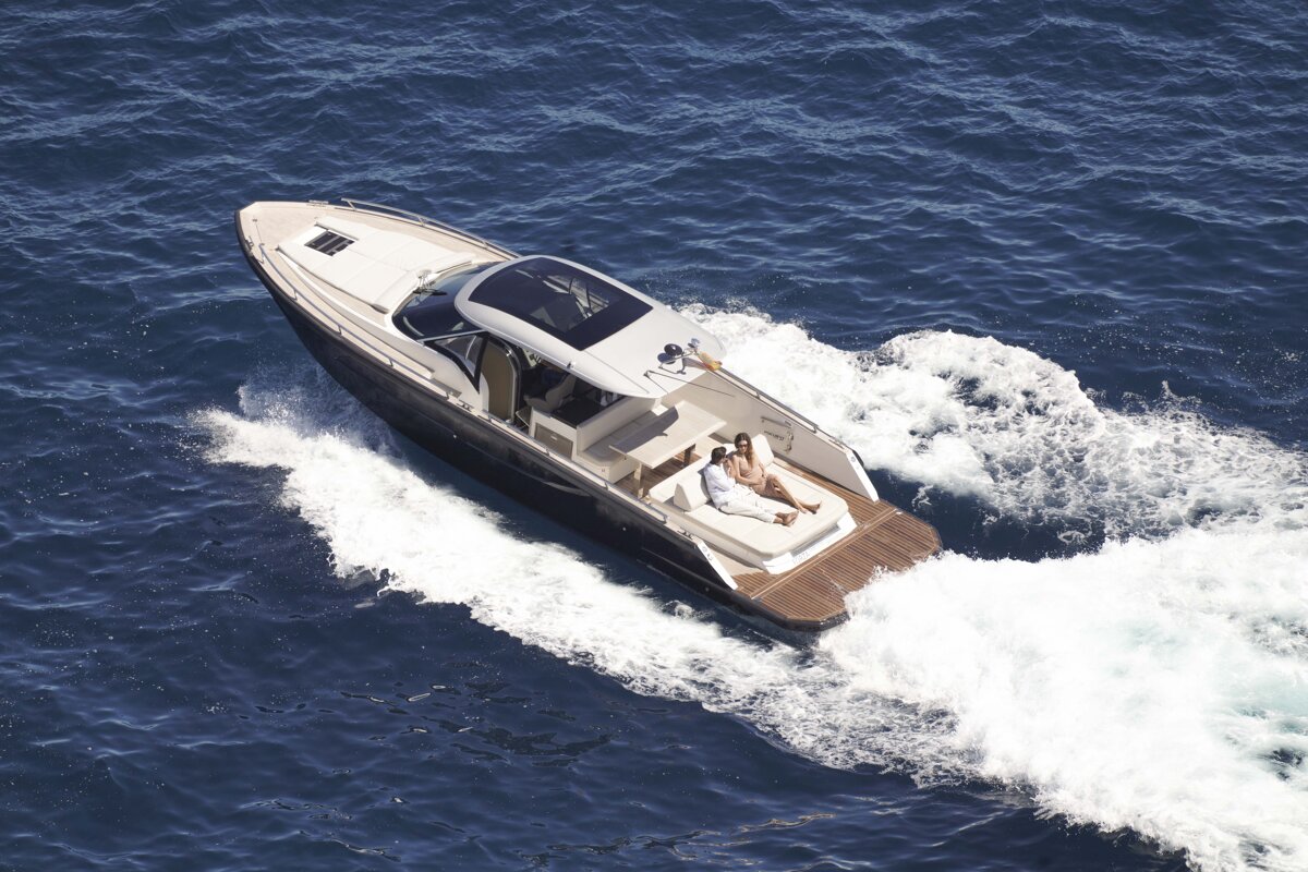 A boat with two people on it is floating in the ocean