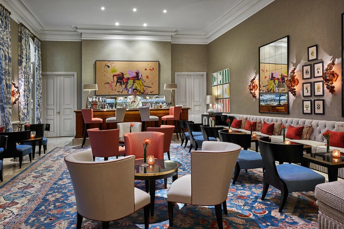 A bar with a painting on the wall behind it