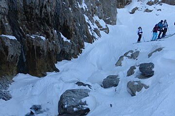 skiers in a gully