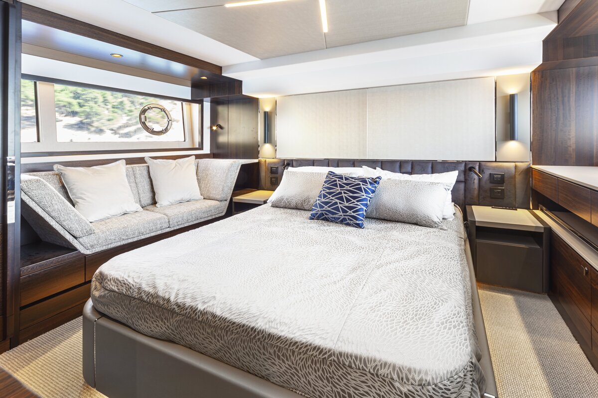 A bedroom with a large bed and a couch