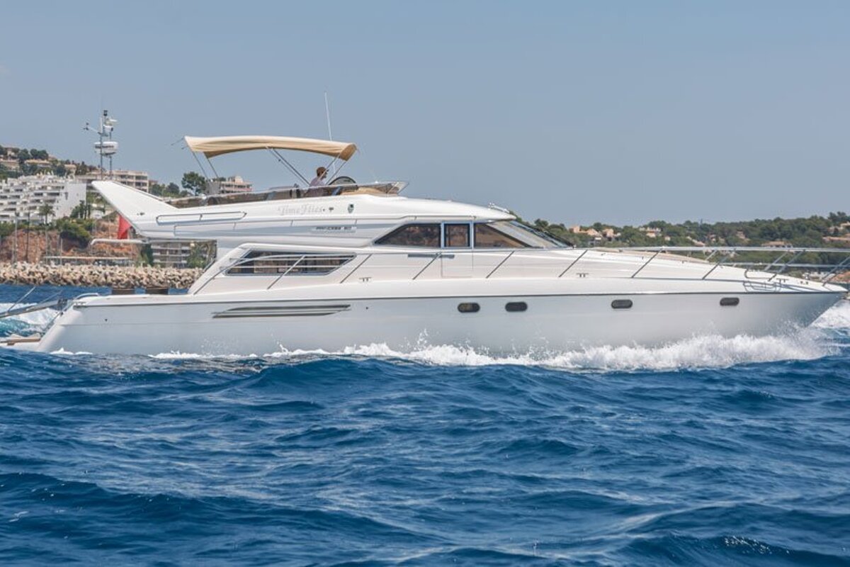 A white boat with the word yacht on the side