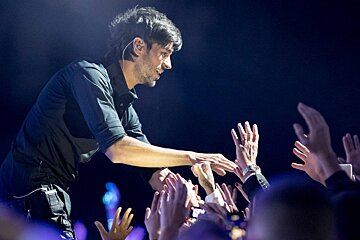 a singer greeting the crowd in Cannes