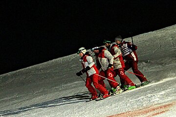 four people joined together skiing