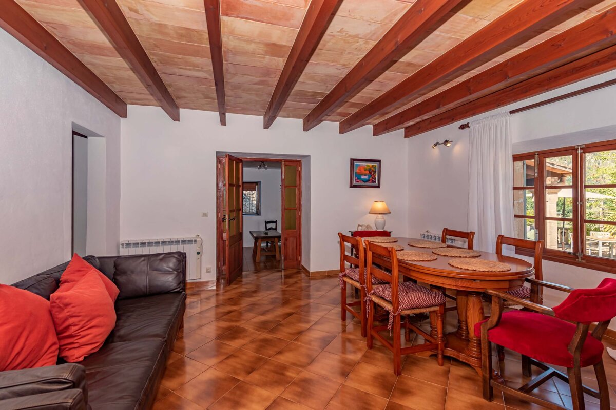 A living room with a couch and a table and chairs