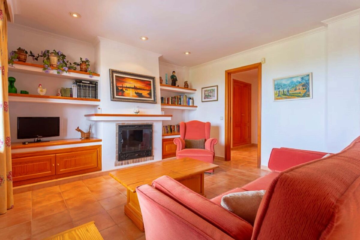 A living room with a fireplace and a television