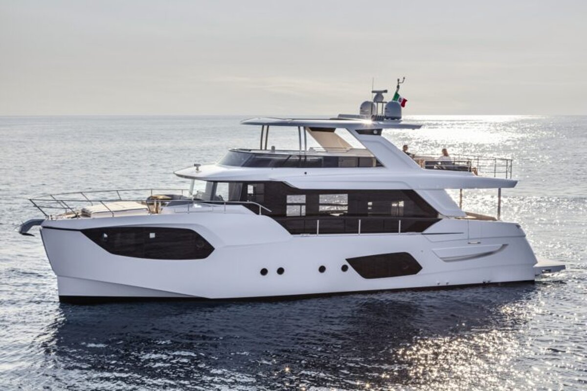 A large white yacht is floating in the ocean