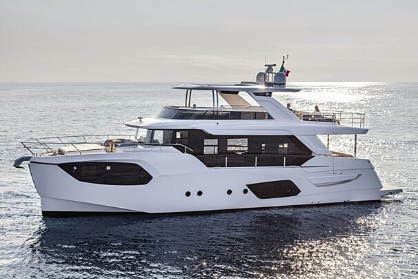 A large white yacht is floating in the ocean