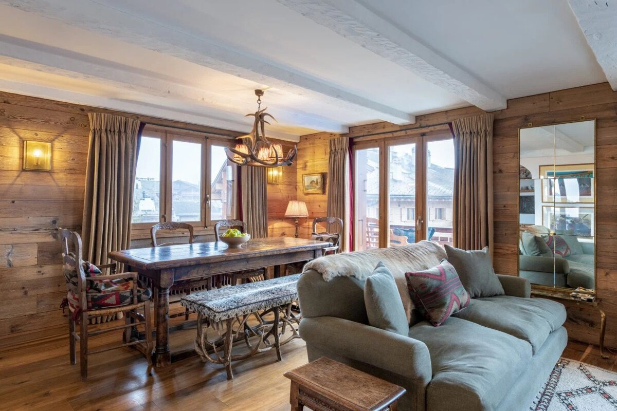 A living room with a couch a table and chairs