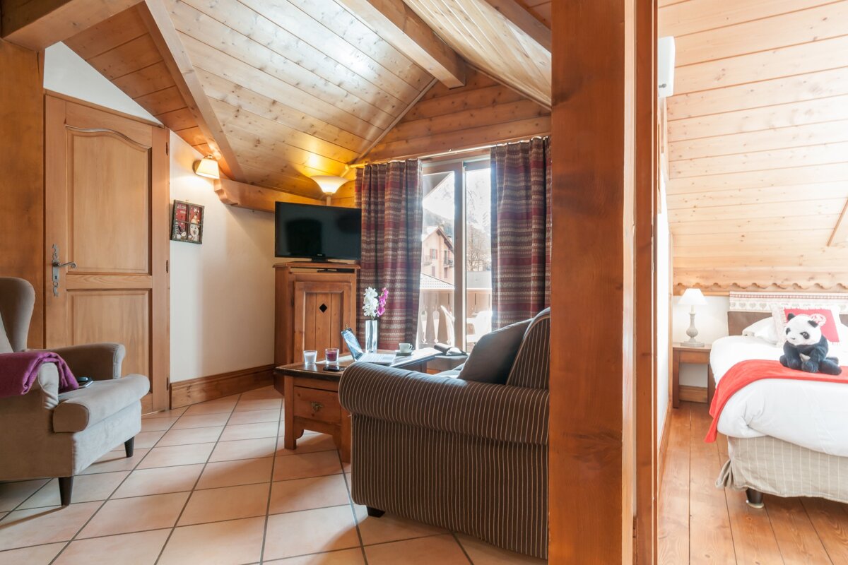 A living room with a couch a chair and a television