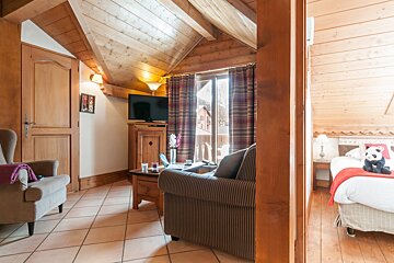 A living room with a couch a chair and a television