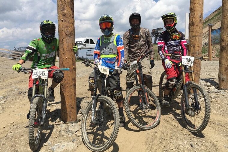 four mountain bikers