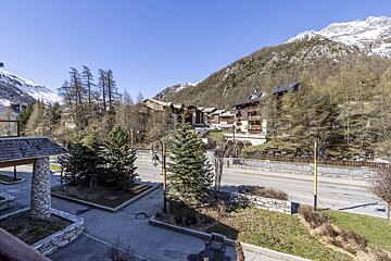 A view of a valley with mountains in the background