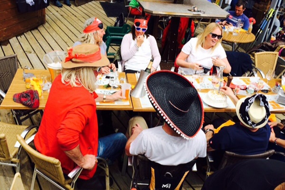 people dressed as pirates sat round a table at a bar