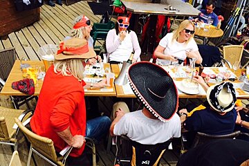 people dressed as pirates sat round a table at a bar