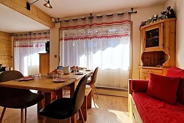 A living room with a dining table and chairs