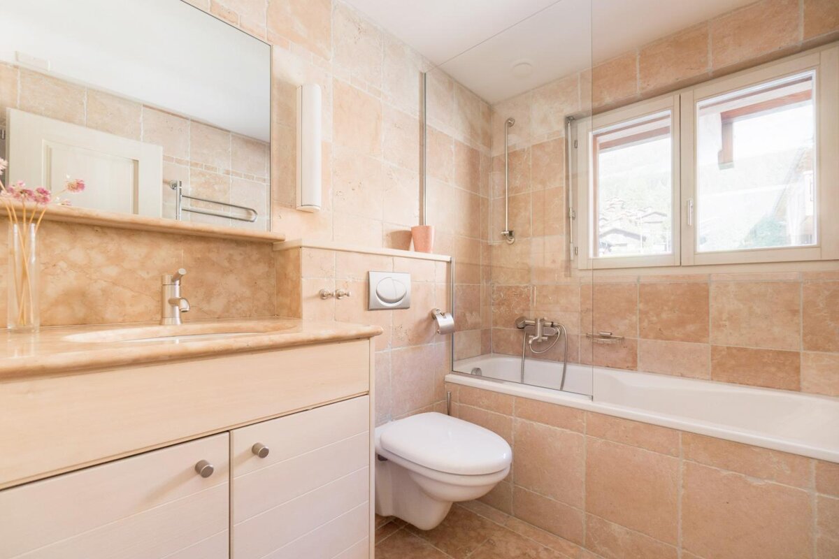 A bathroom with a toilet a sink and a bathtub