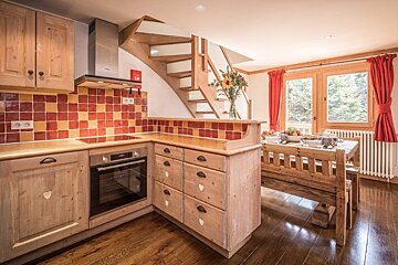 A kitchen with wooden cabinets and a stove top oven