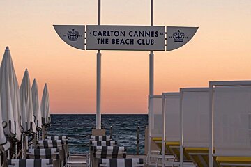 A sign for the carlton cannes beach club
