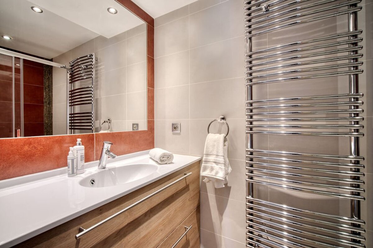A bathroom with a sink and a towel rack