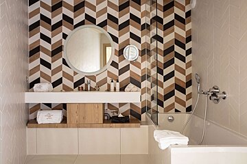 A bathroom with a chevron patterned wall