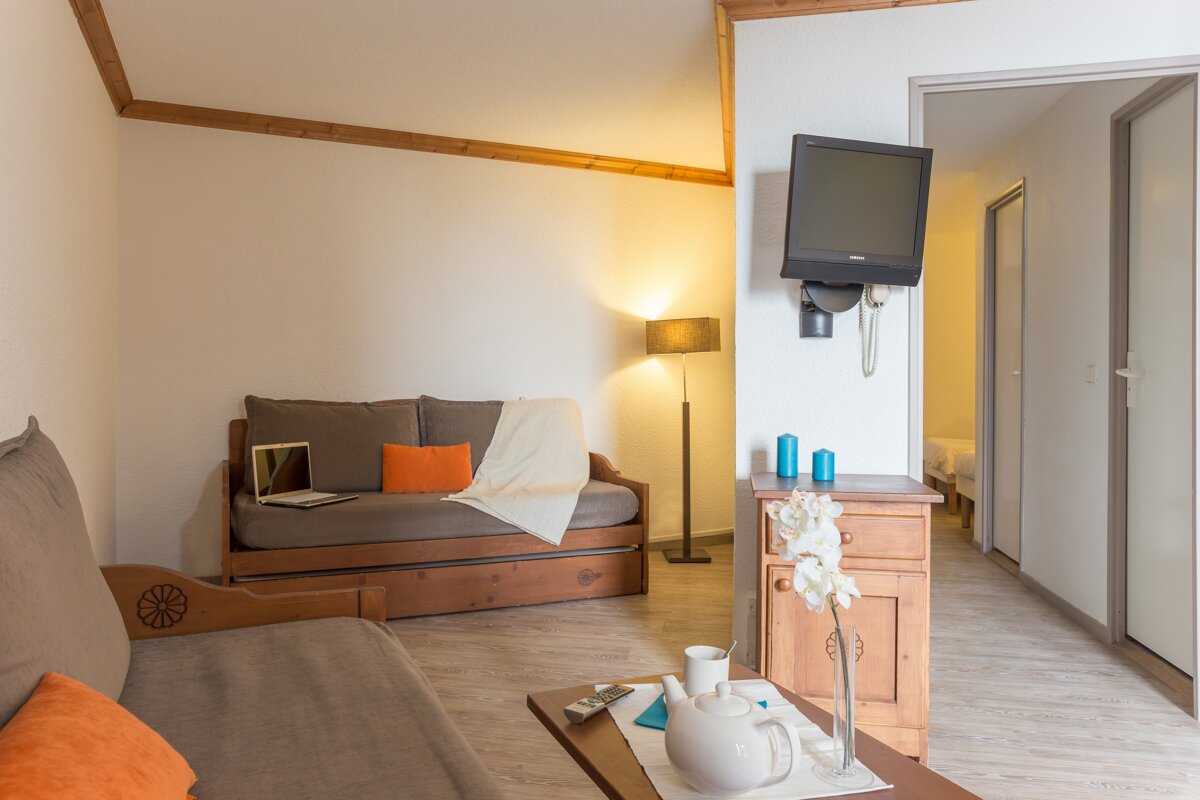 A living room with a couch and a flat screen tv